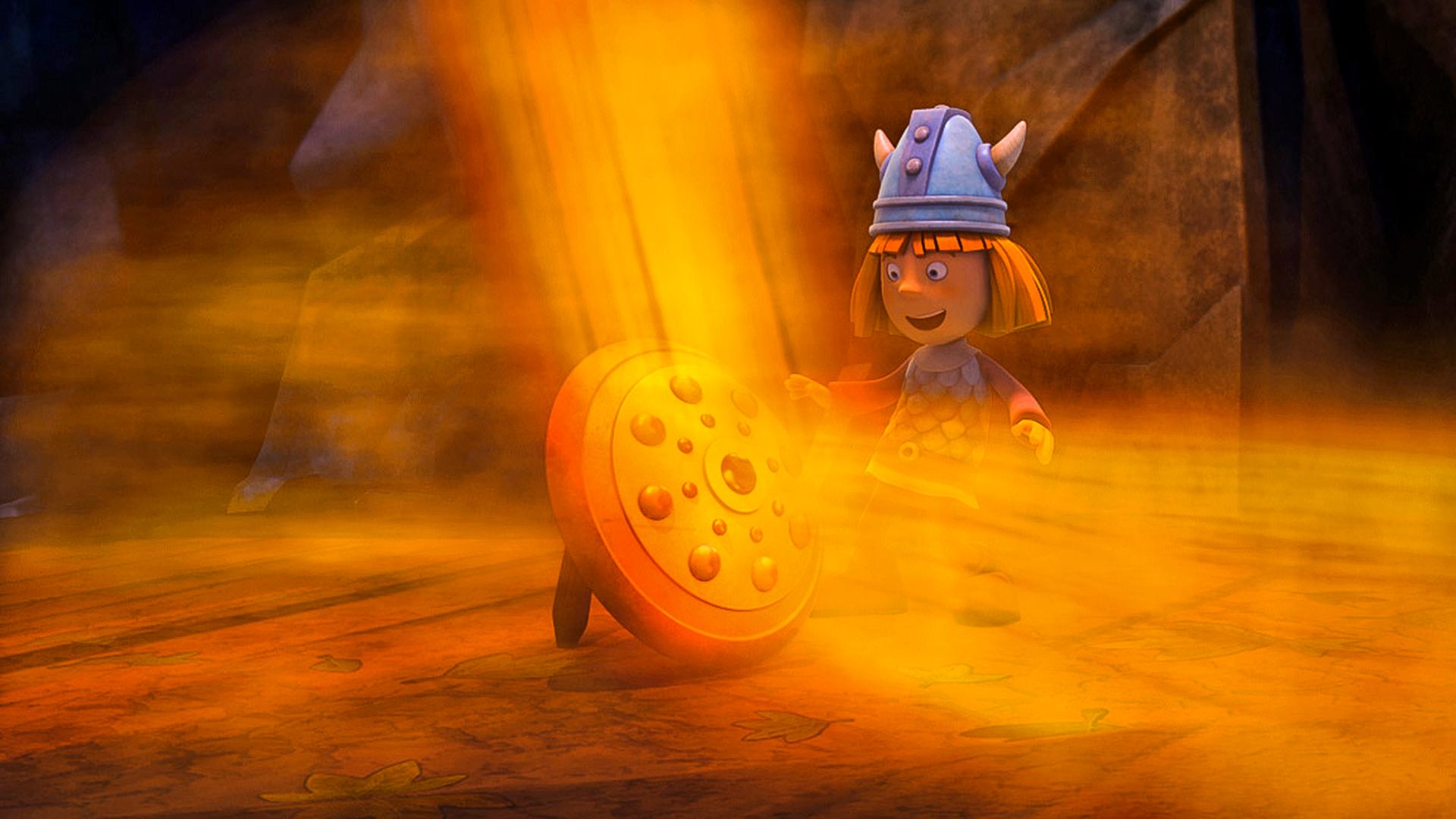 Wickie steht in der Höhle vor einem Schild, von dem ein enormer orange-goldener Lichterglanz ausgeht.