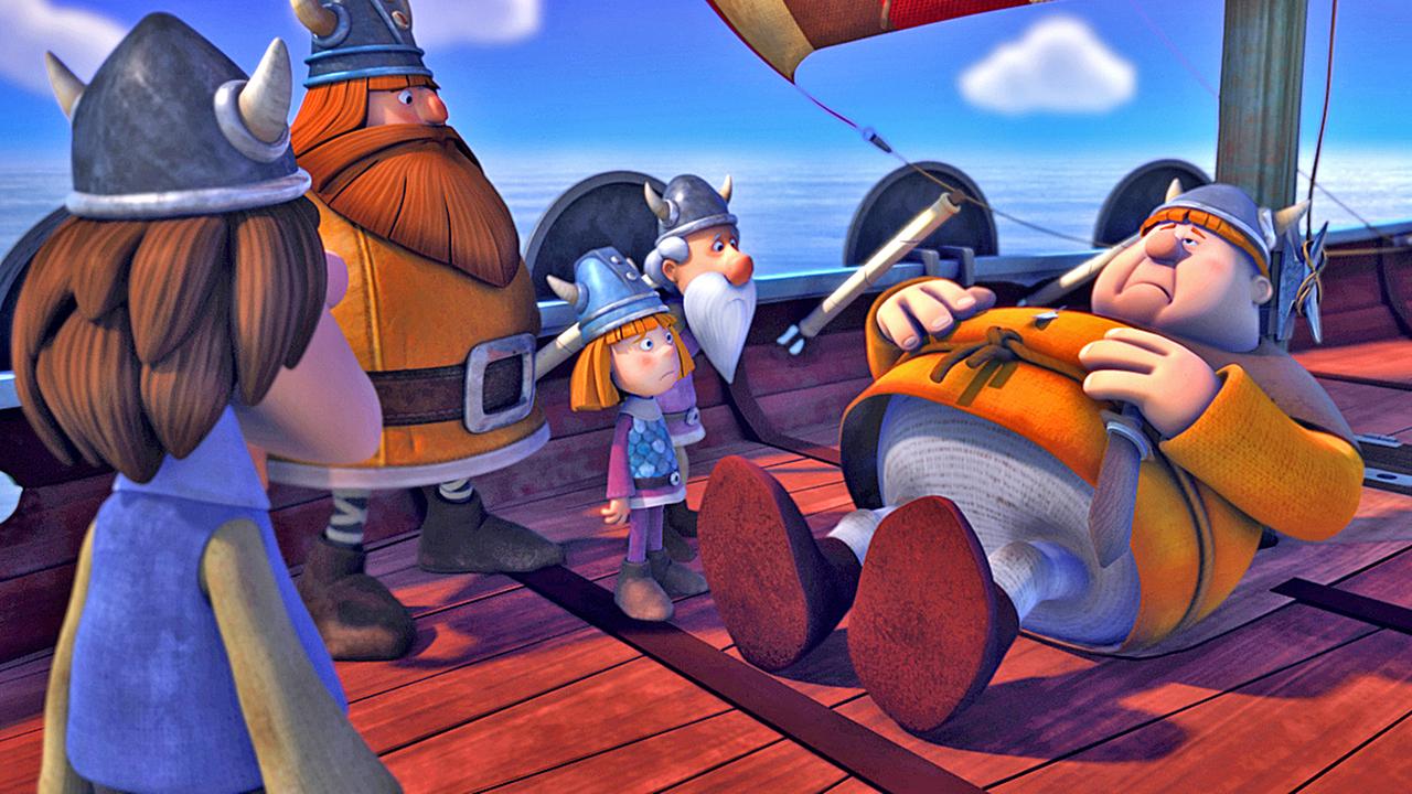 Faxe liegt mit Bauchschmerzen an Deck des Schiffes und hält sich den Bauch. Um ihn herum stehen Urobe, Halvar, Wickie und Tjure.