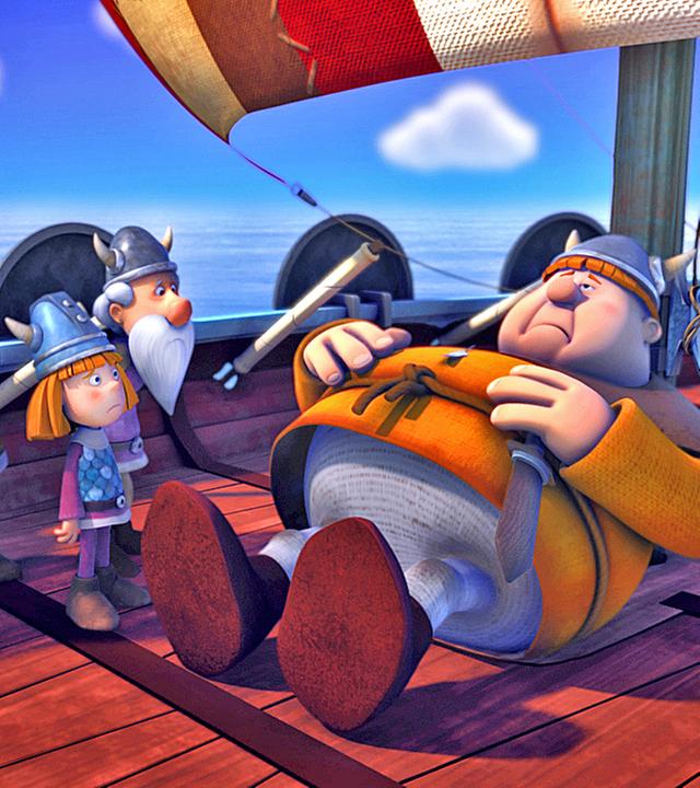 Faxe liegt mit Bauchschmerzen an Deck des Schiffes und hält sich den Bauch. Um ihn herum stehen Urobe, Halvar, Wickie und Tjure.