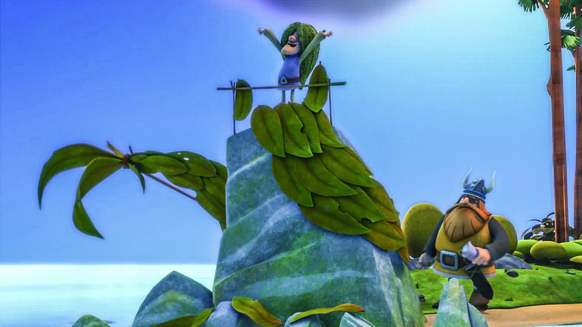 Tjure steht als Meerjungfrau verkleidet auf einem Felsen. Halvar versteckt sich dahinter. 