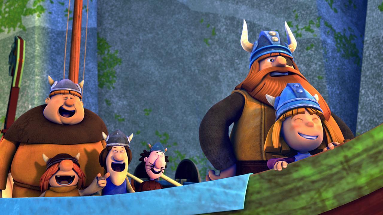 Die Wikinger stehen lachend auf dem Boot. Rechts stehen Wickie und Halvar, links hinter ihnen die übrigen Wikinger.