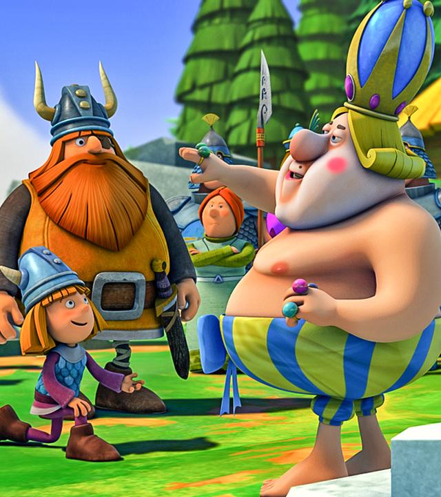 Der schwedische König probiert Wickies unsichtbare Rüstung an. Wickie kniet neben ihm.