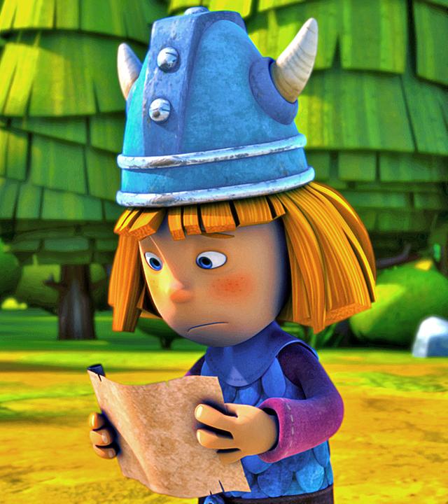 Wickie hält eine Schriftrolle in beiden Händen und liest darauf eine Aufgabe für seine Prüfung zum "wahren Wikinger". Er sieht besorgt aus.