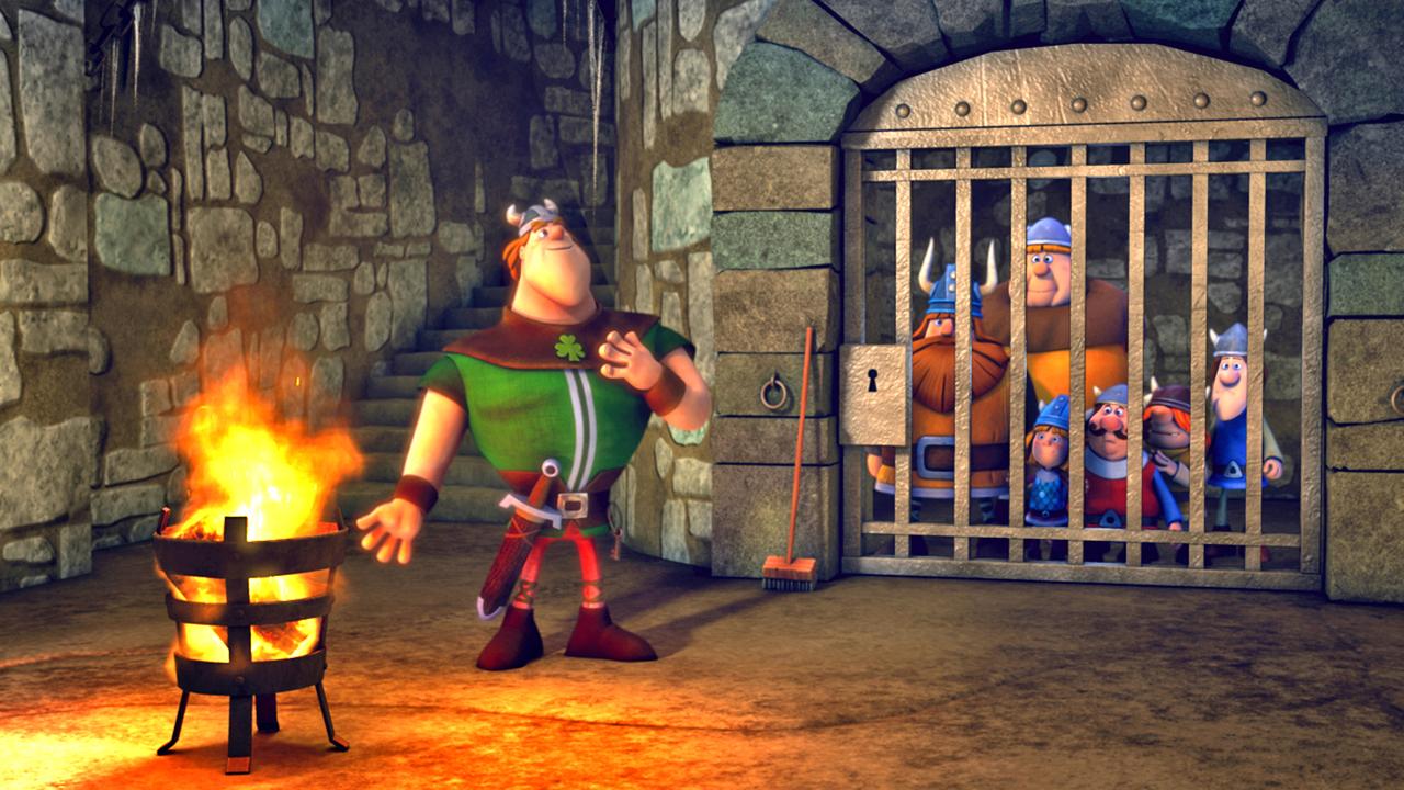 Die Wikinger sind hinter Gittern gefangen. Vor dem Gefängnis steht ein Ire und wärmt sich am Feuer.