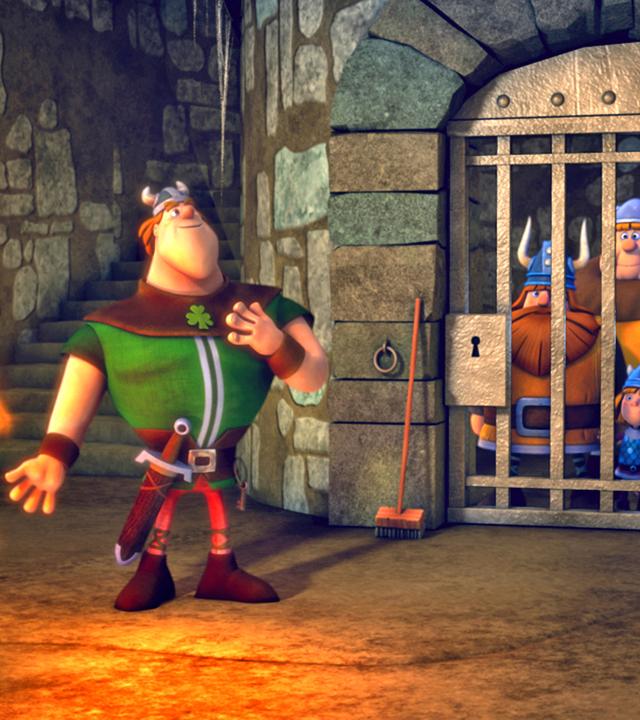 Die Wikinger sind hinter Gittern gefangen. Vor dem Gefängnis steht ein Ire und wärmt sich am Feuer.