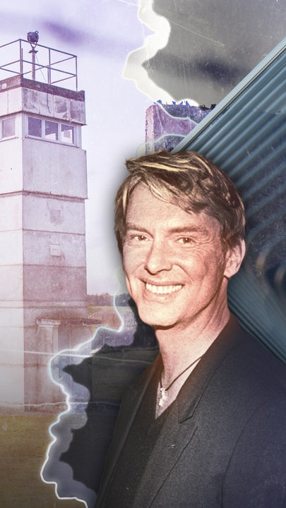 Links ein Wachturm der DDR-Grenze, in der Mitte verläuft eine Linie, die die DDR-Grenze darstellt und rechts ein Bild von Wolfgang Joop