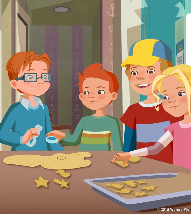 Alle Möwenweg-Kinder backen zusammen Kekse. Sie stehen alle um einen großen Tisch herum.