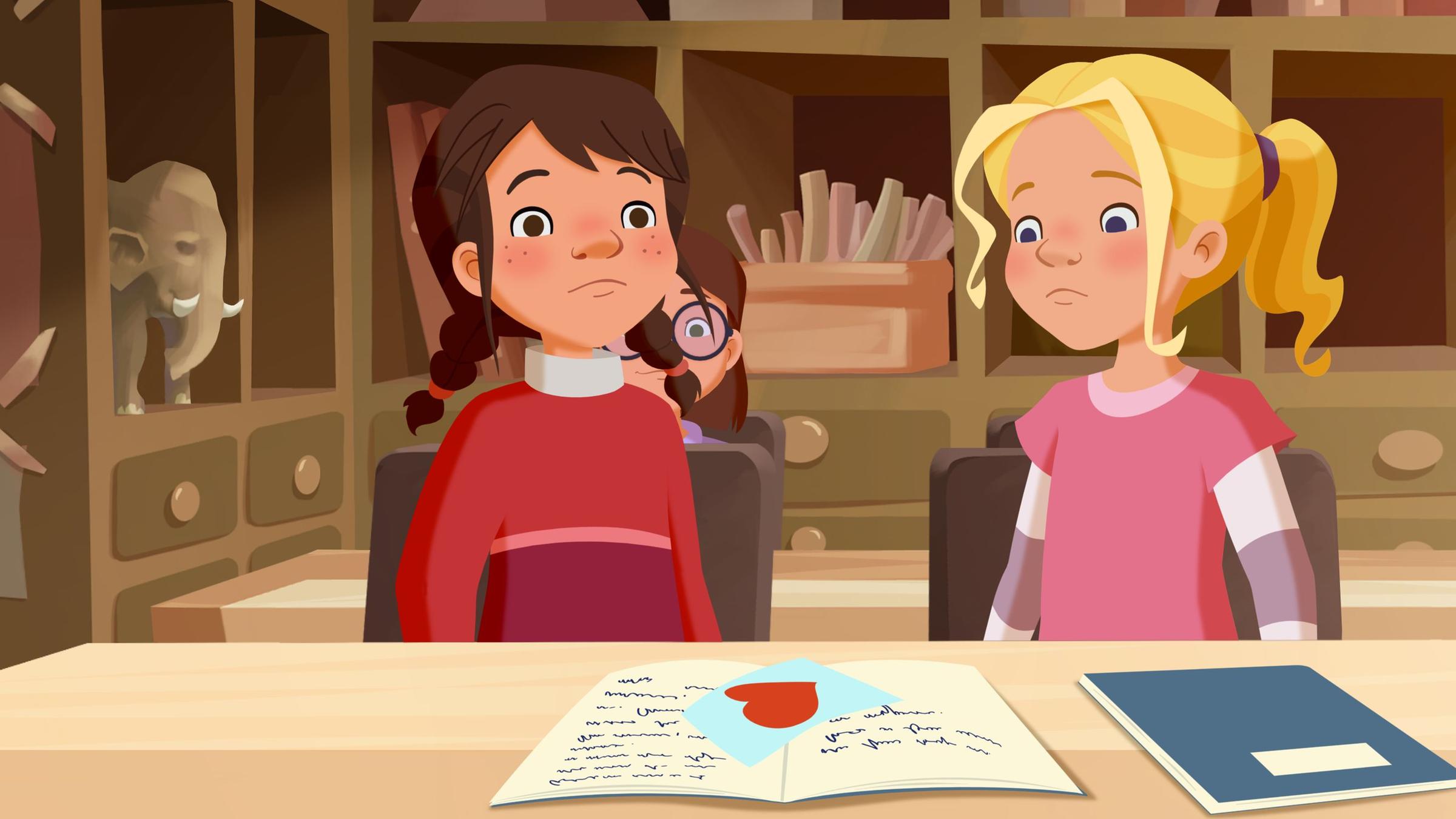 Als Tara einen Liebesbrief bekommt, ist sie ratlos. Tieneke sitzt neben ihr.