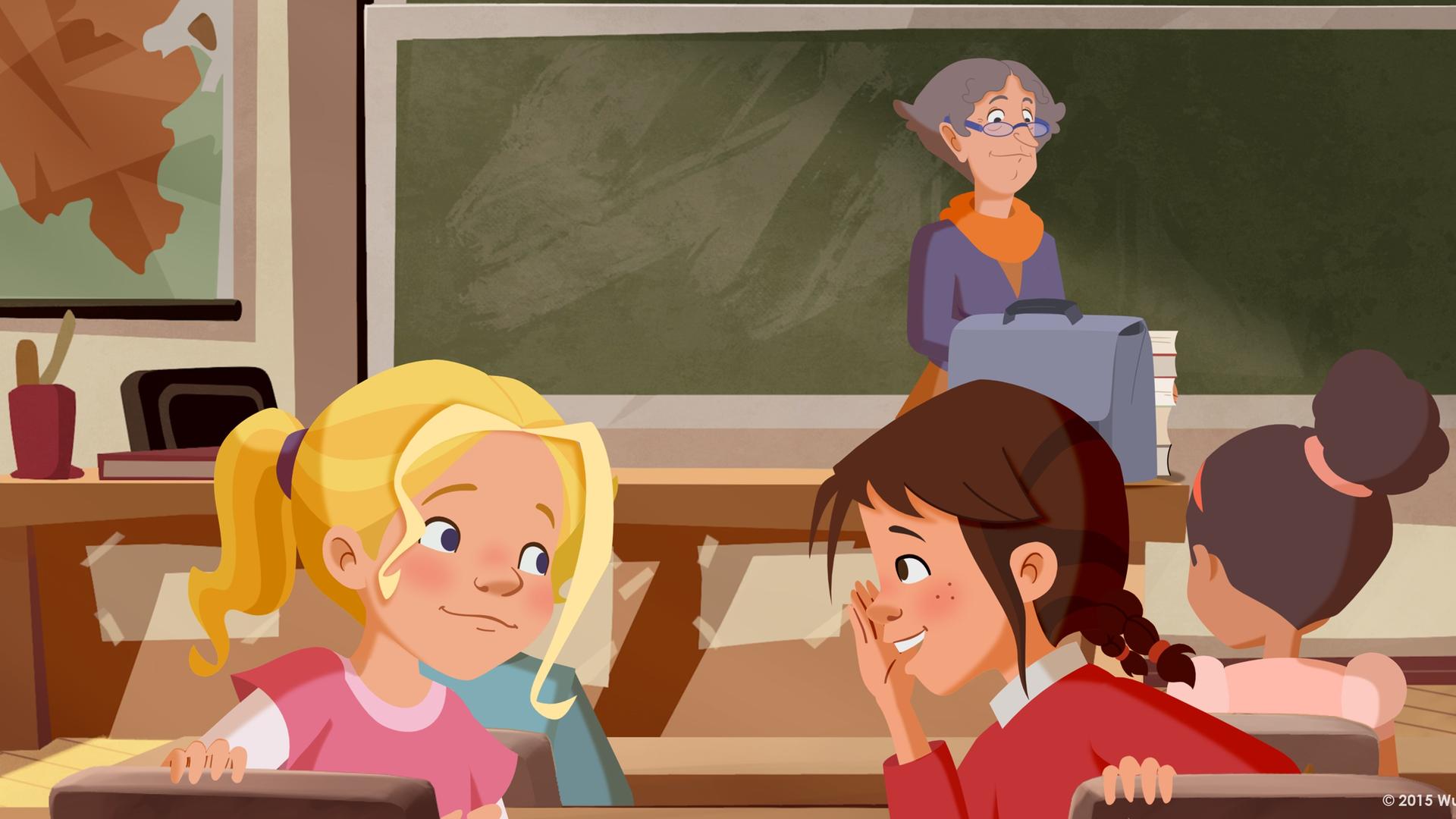 Tara und Tieneke planen schon im Unterricht ihre Aprilscherze und flüstern sich ihre Ideen zu. Die Lehrerin bemerkt es nicht.