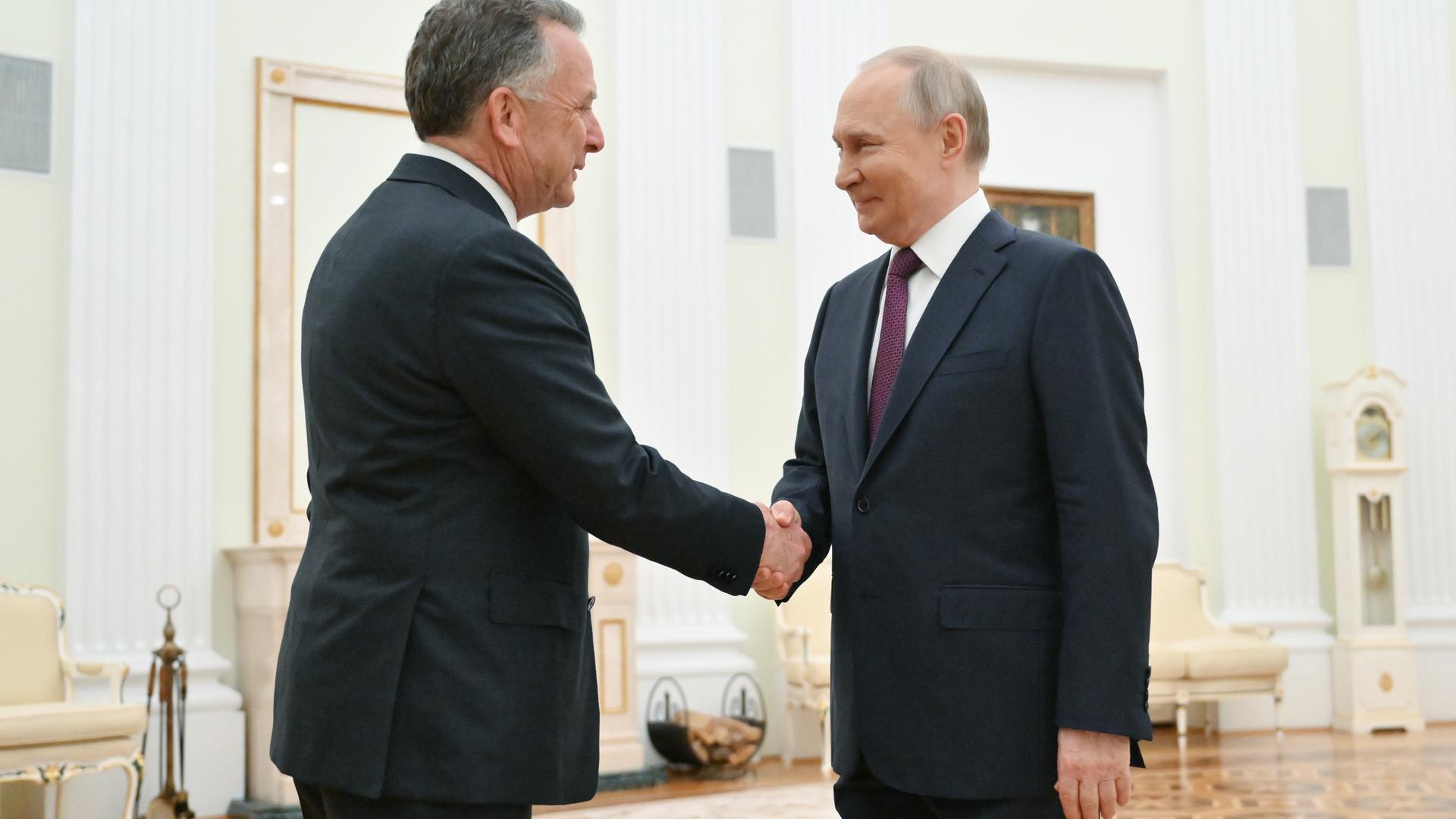 Russian President Vladimir Putin (R) shakes hands with US President Special Envoy Steve Witkoff (L) before a meeting at the Kremlin in Moscow.