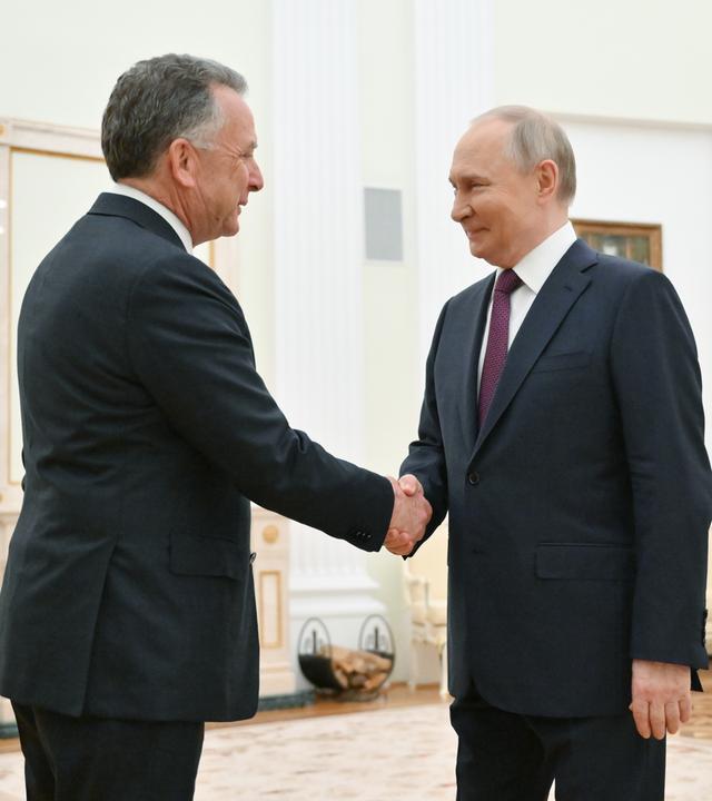 Russian President Vladimir Putin (R) shakes hands with US President Special Envoy Steve Witkoff (L) before a meeting at the Kremlin in Moscow.