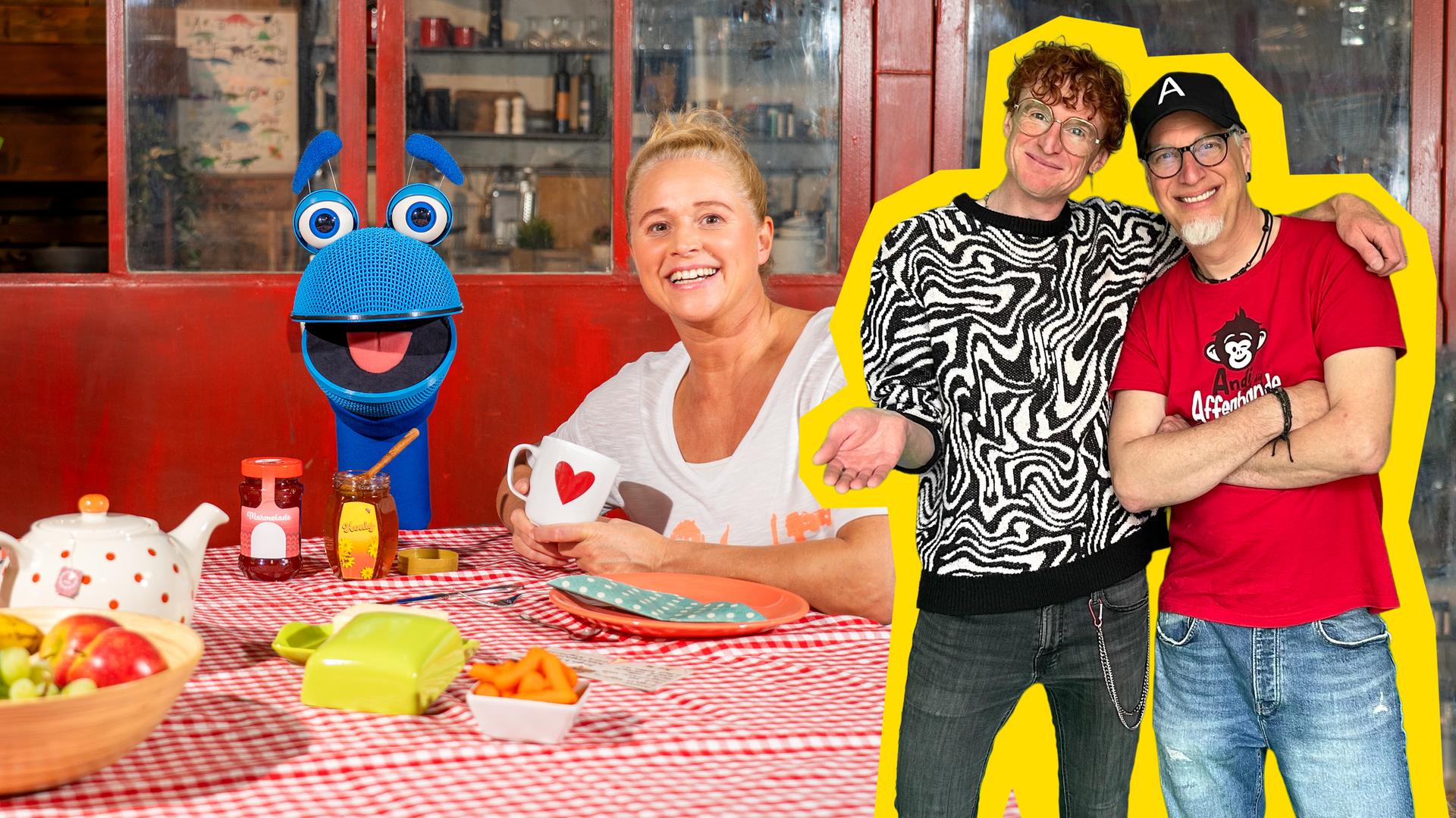 Singding (l.) und Singa (r.) sitzen am gedeckten Frühstückstisch. Im rechten Bildrand stehen Tommie von OK Tilda und Andi von Andi und die Affenbande.