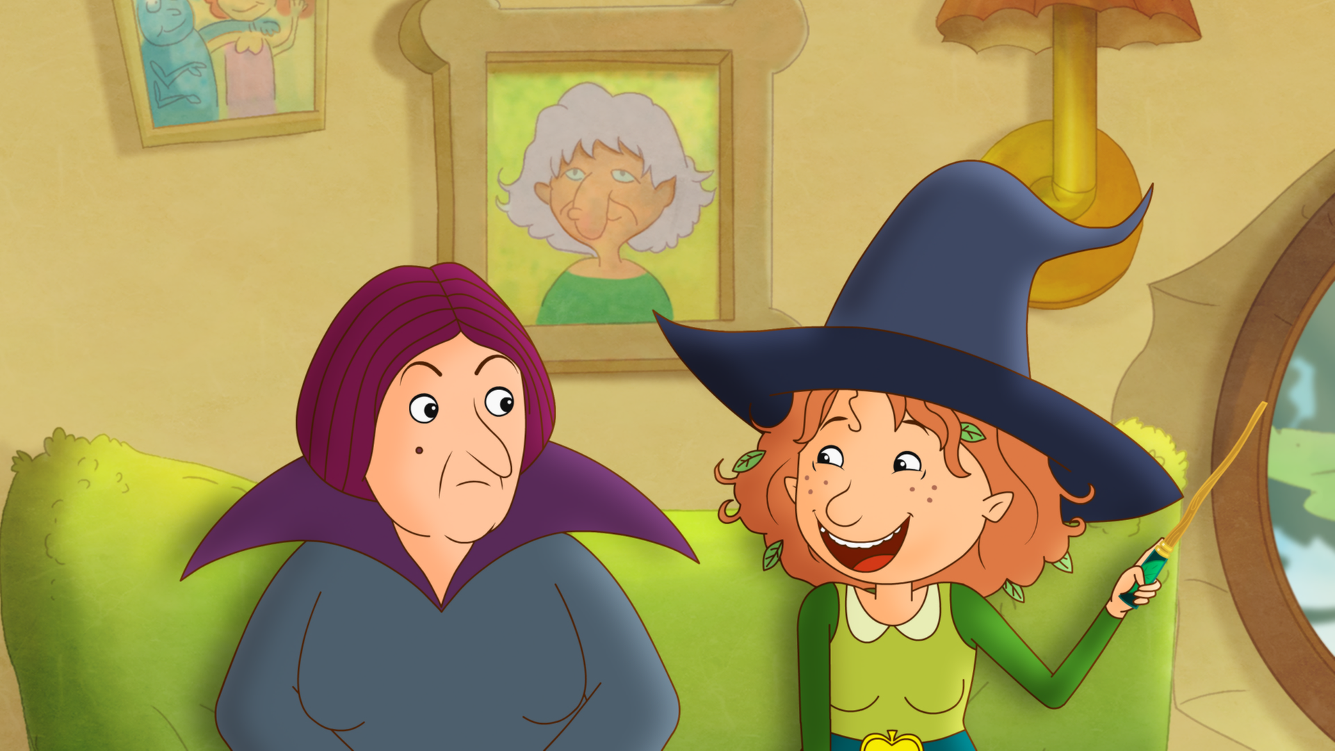 Petronella steht mit ihrem Zauberstab lachend neben Oberhexe Pestilla.