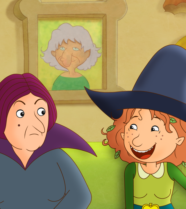 Petronella steht mit ihrem Zauberstab lachend neben Oberhexe Pestilla.