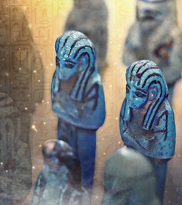 Blaue Tonfiguren voreiner Hieroglyphenwand mit Nebel- und Funkeneffekten.