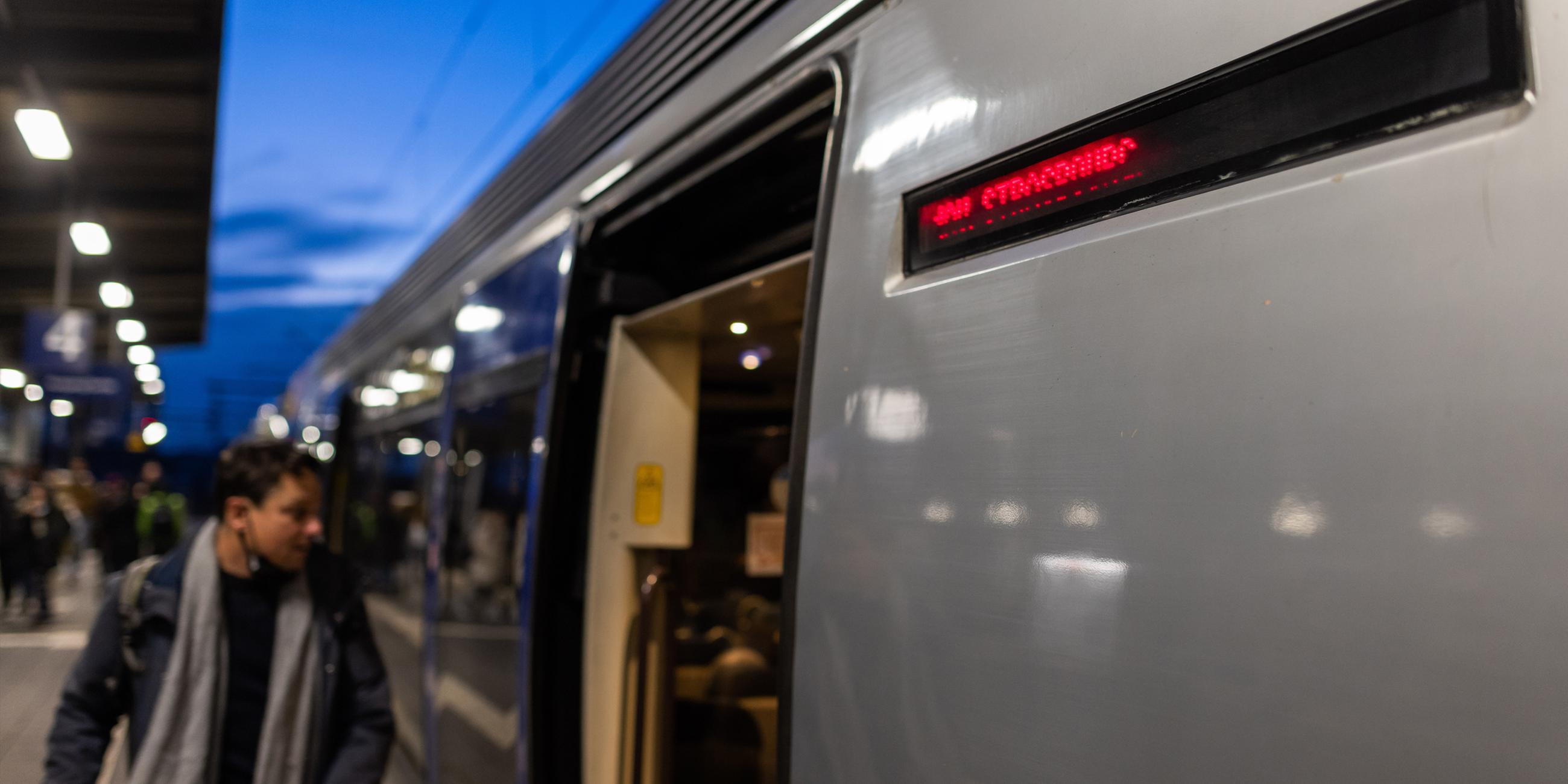 Ein Mann steigt auf dem Bahnhof Kehl in einen Zug mit dem Fahrtziel Straßburg. 